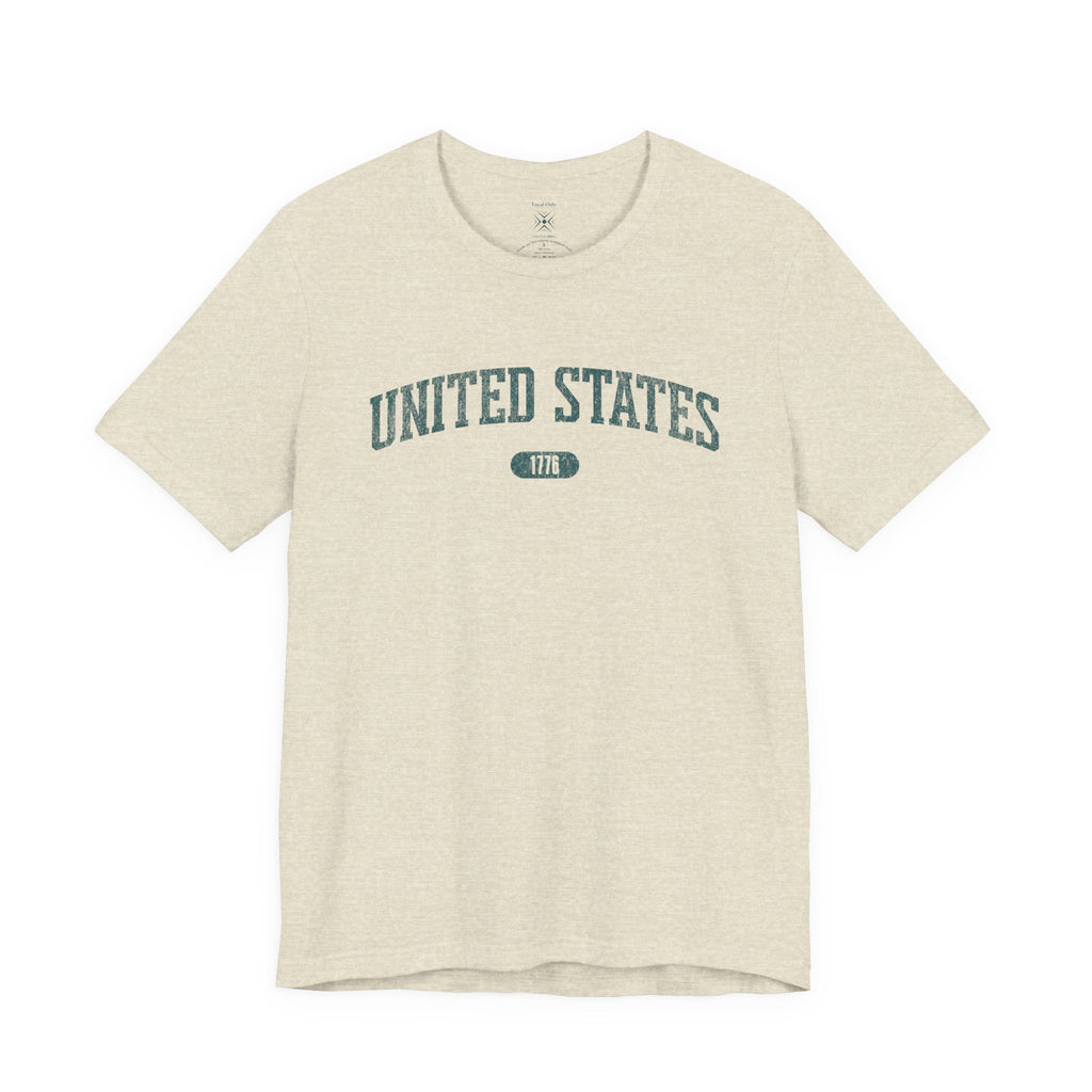 Heather Prism Natural t-shirt with 'UNITED STATES 1776' in teal collegiate text.