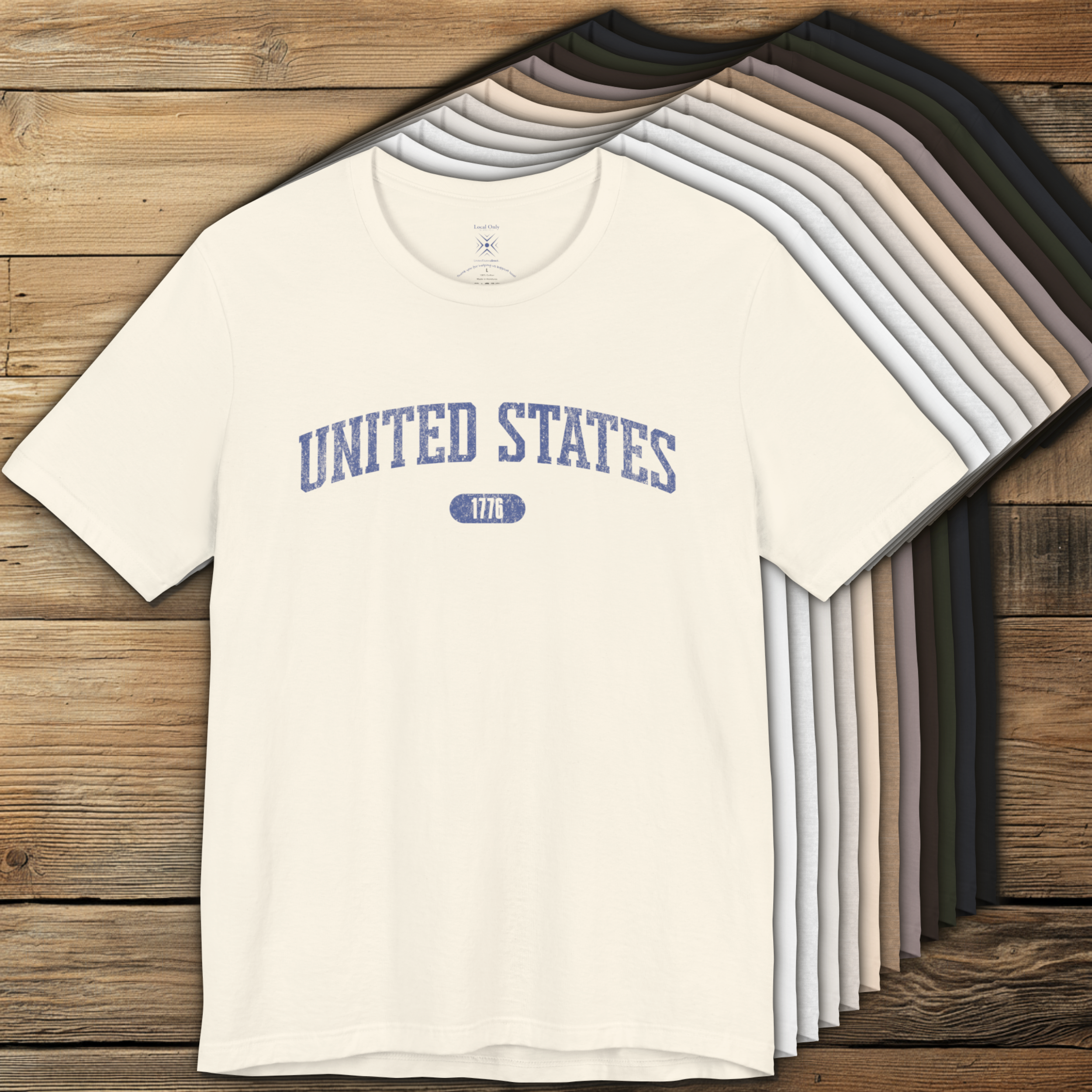 Color options of premium varsity tees with 'UNITED STATES 1776' in muted cornflower blue.