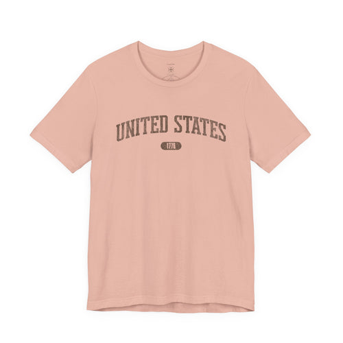 Peach t-shirt with 'UNITED STATES 1776' in brown collegiate text.