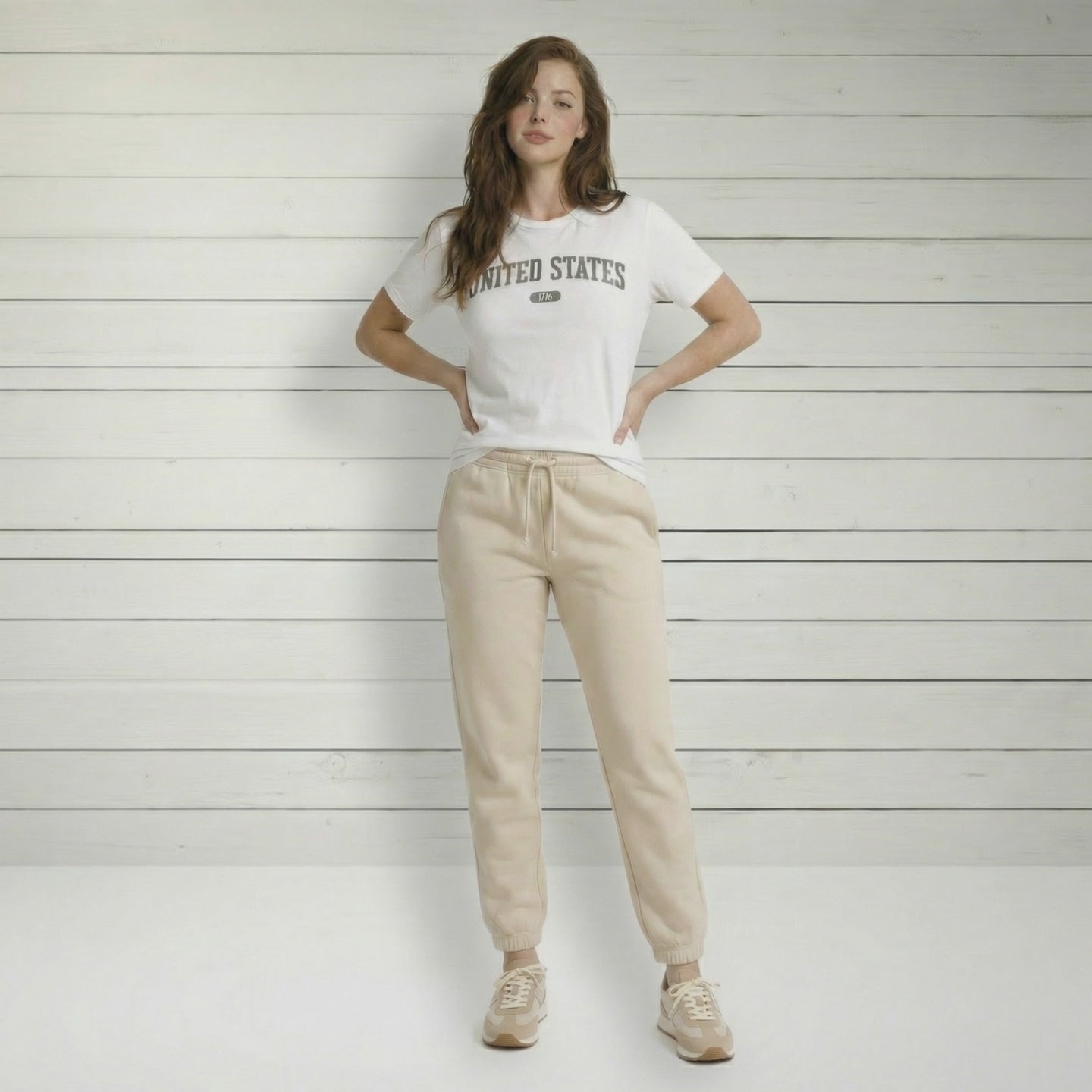 Video of a woman wearing the white t-shirt with 'UNITED STATES 1776' in gray collegiate text.