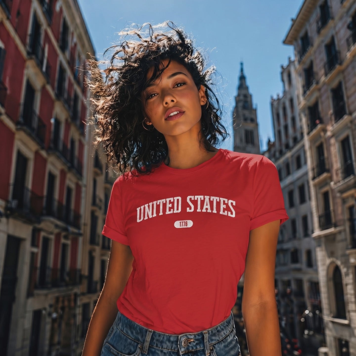 Video of a woman wearing the Red t-shirt with 'UNITED STATES 1776' in white collegiate text.