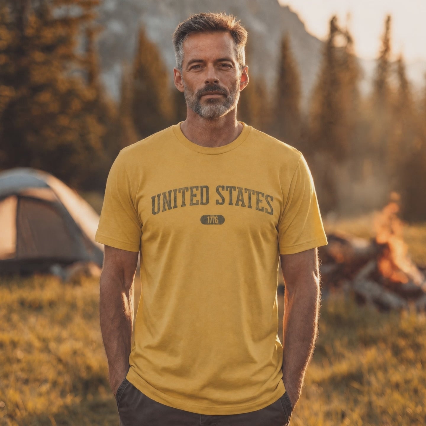 Video of a man wearing a Heather Mustard t-shirt with 'UNITED STATES 1776' in olive green collegiate text.